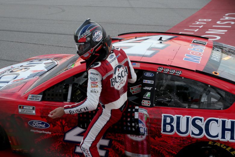Kevin Harvick gets out of his car.