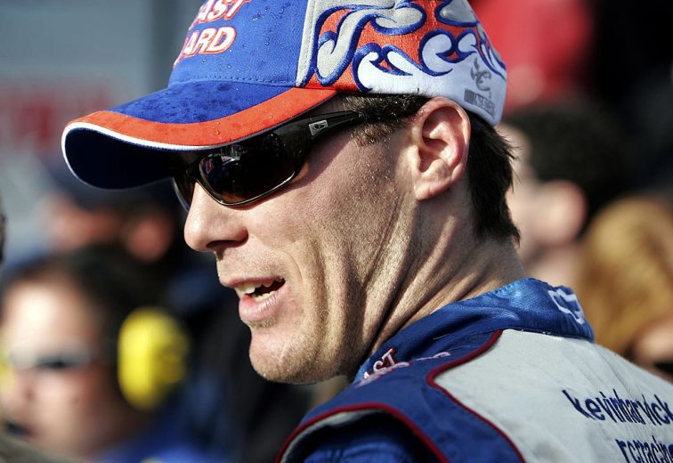 Kevin Harvick looks on.