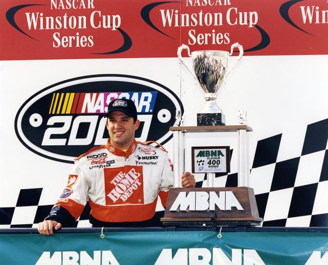 Tony Stewart poses with trophy in Victory Lane.
