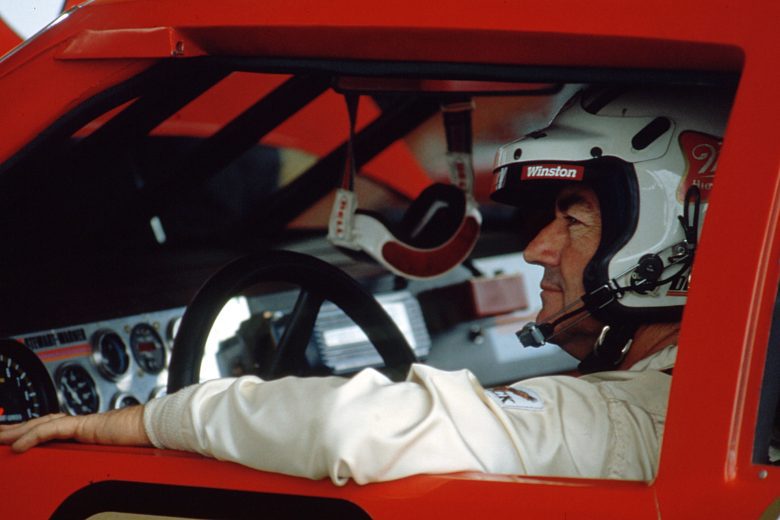 Bobby Allison sits in his race car