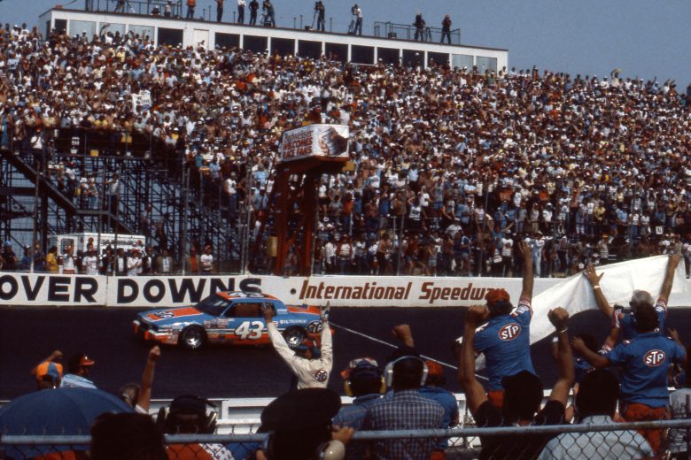 Richard Petty crosses the finishes in his race car at Dover International Speedway.