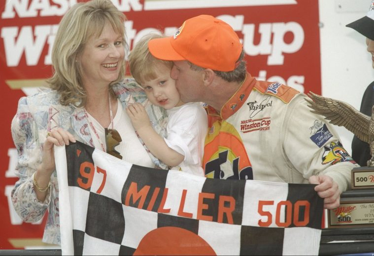 Ricky Rudd holds up checkered flag with his family