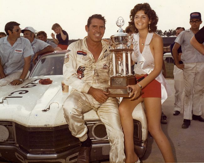 David Pearson holds trophy with Miss Atlanta International Raceway