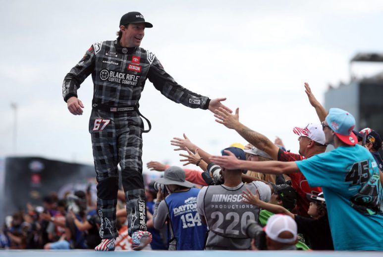 Travis Pastrana high-fives the crowd.