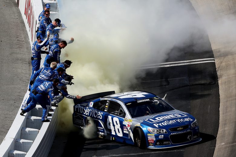 Jimmie Johnson does burnout in front of his pit crew