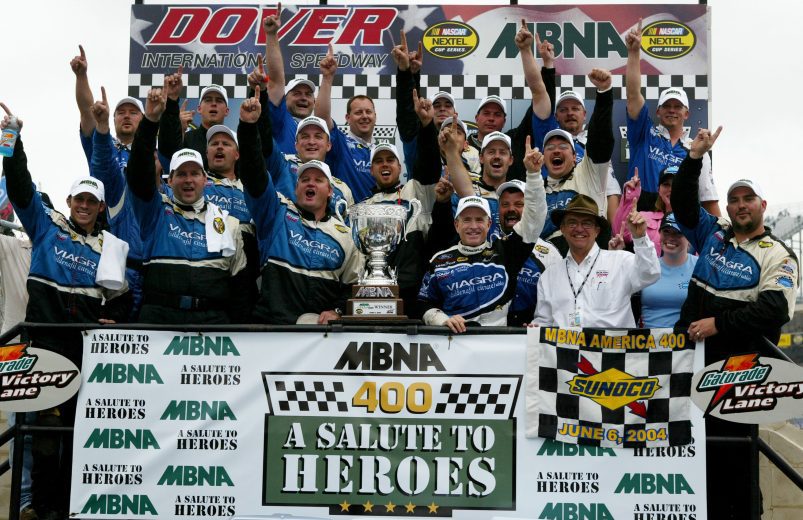 Mark Martin and crew hold up racing winning banner in Victory Lane.