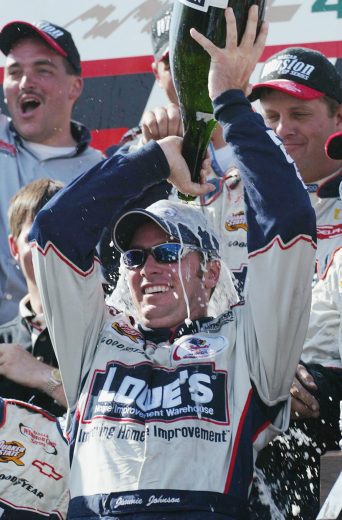 Jimmie Johnson pours champagne on his head.