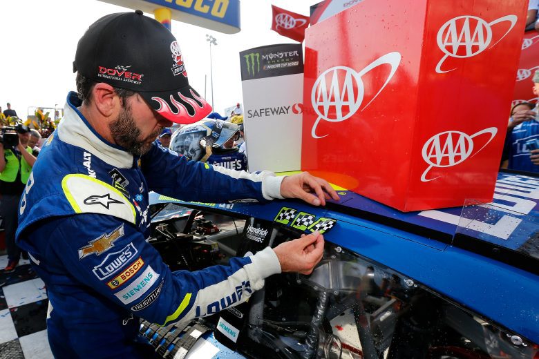 Jimmie Johnson places winner sticker on car