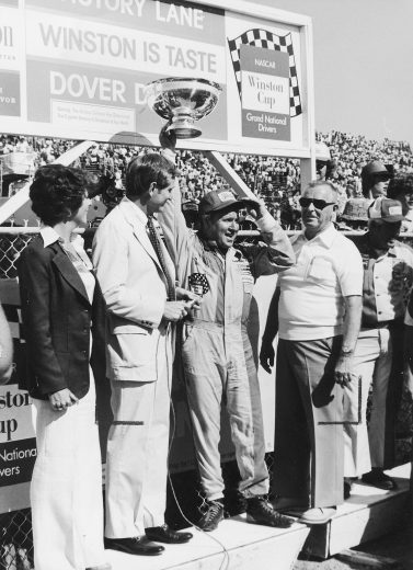 Cale Yarborough poses with trophy in Victory Lane.