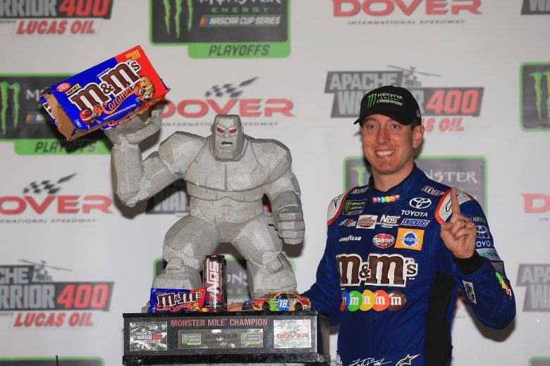 Kyle Busch poses next to race winning trophy