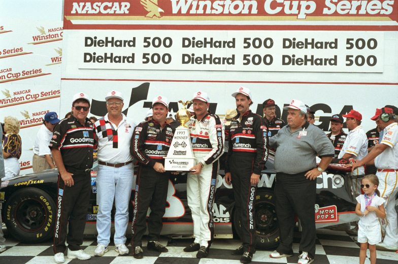 Dale Earnhardt poses with trophy in Victory Lane.