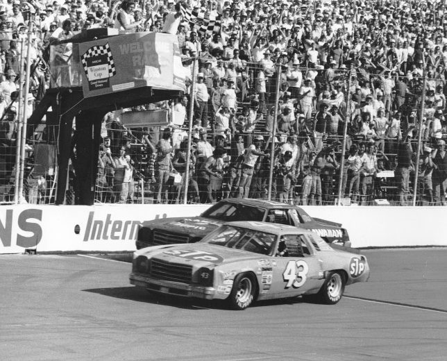 Richard Petty crossing the finish line in his race car.