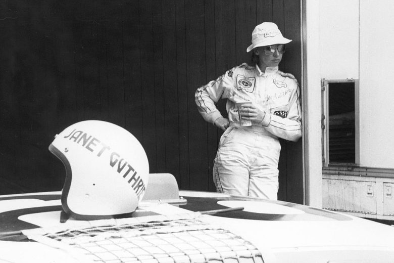 Janet Guthrie looks on.