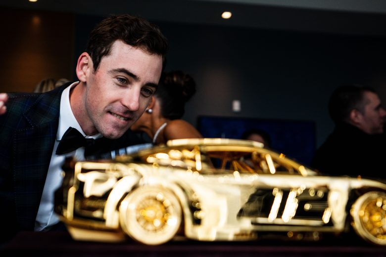 Ryan Blaney gets up close to gold car.