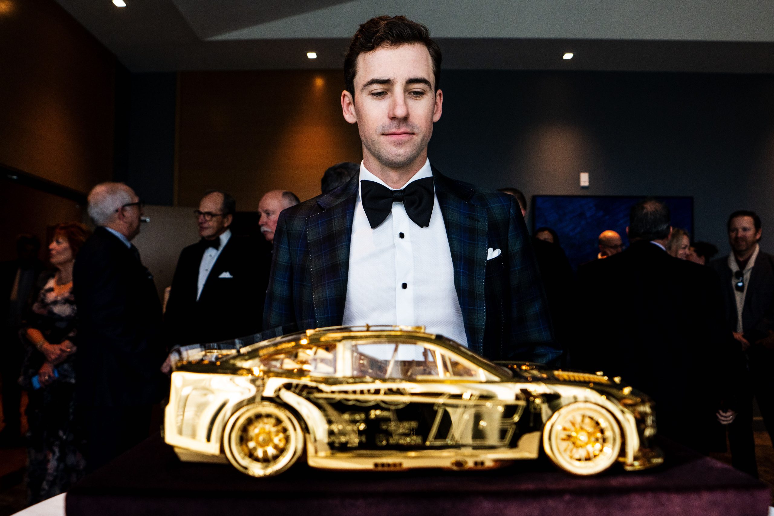 Ryan Blaney gets up close to gold car.