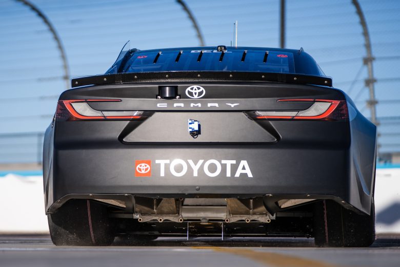 A detailed look at the rear undercarriage of Christopher Bell's No. 20 Toyota during NASCAR Cup Series testing at Phoenix Raceway.