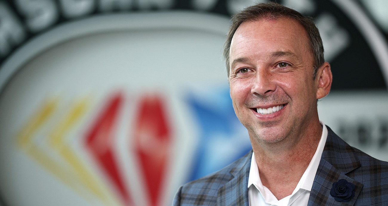 Chad Knaus smiles for a picture during a press conference.