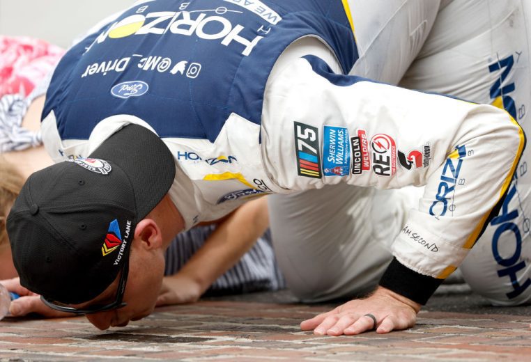 Michael McDowell kisses the iconic bricks after winning at Indianapolis.