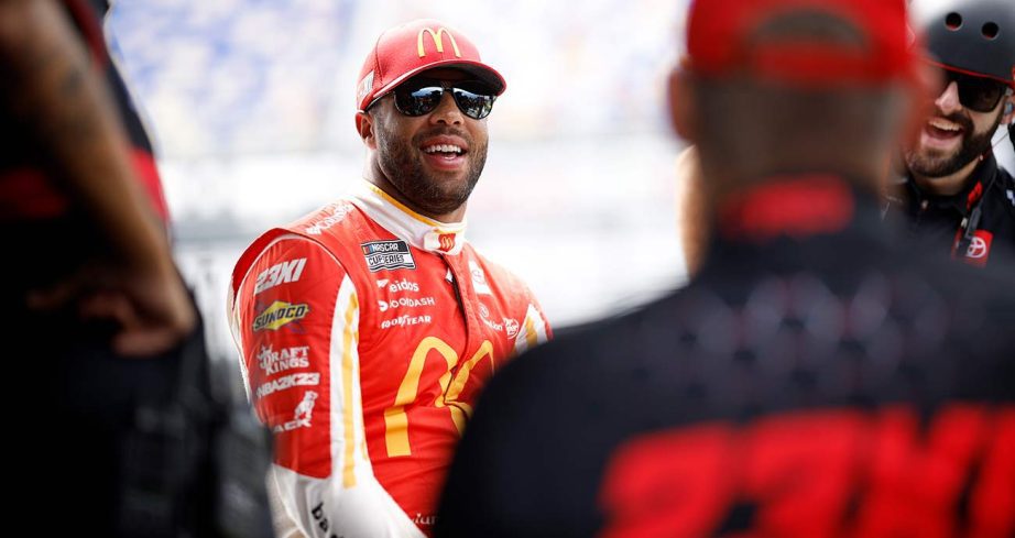 Bubba Wallace chats with his 23XI Racing crew on the grid at Darlington Raceway