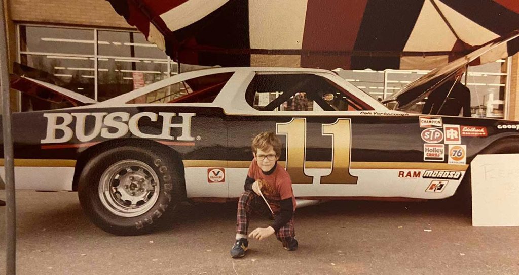 Zack Albert, age 7 or 8, with Cale Yarborough's No. 11 show car at an auto parts store in Winston-Salem, N.C.