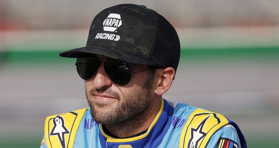 Chase Elliott smiles and looks on