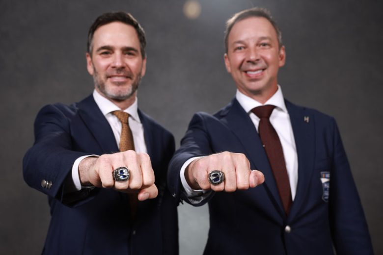 Johnson and Knaus pose for a photo with their Hall of Fame rings