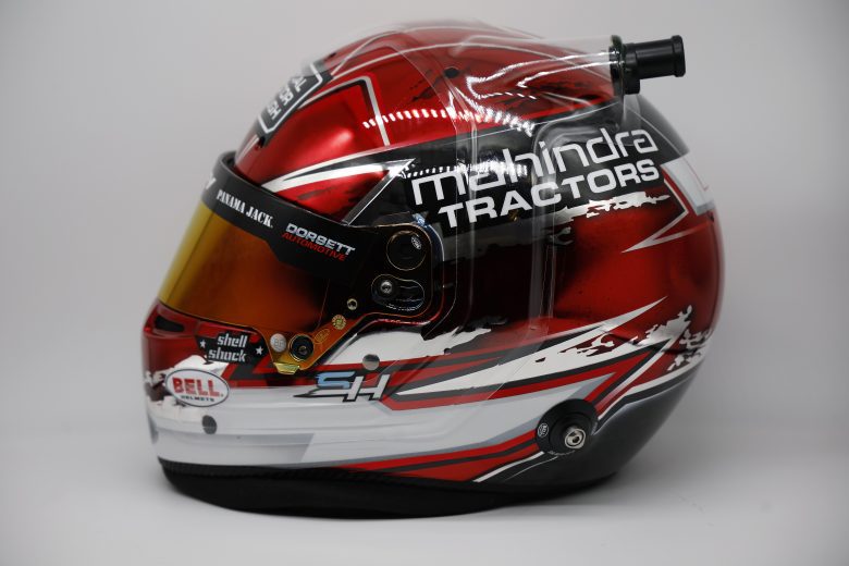 Side profile view of Chase Briscoe's red and white racing helmet