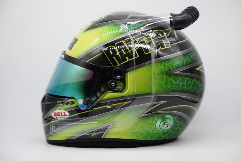 Side view of William Byron's green and black racing helmet.