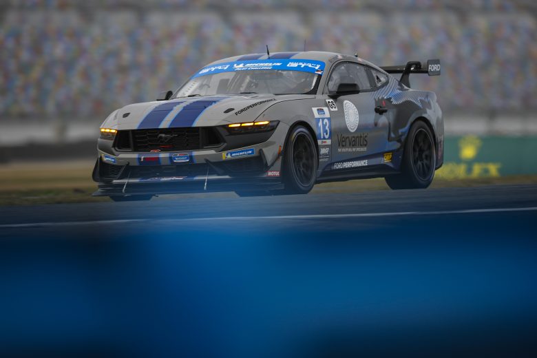 Gray and blue ford mustang driving at Daytona