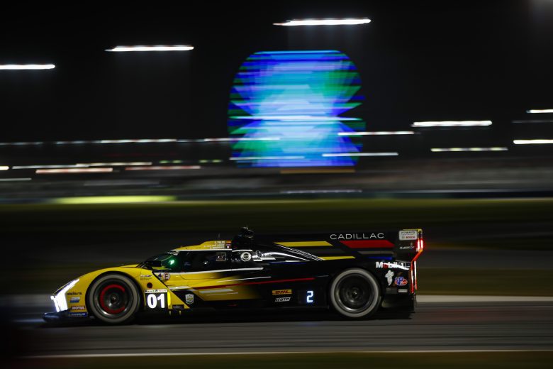 Cadillac race car driving at night