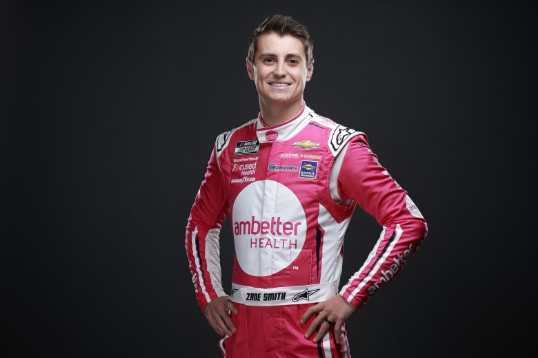 Zane Smith poses in fire suit