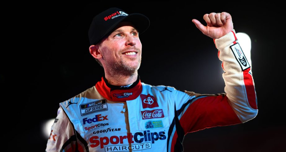Denny Hamlin gives the thumbs-up sign after getting out of his car following his victory in the Busch Light Clash at the LA Coliseum.
