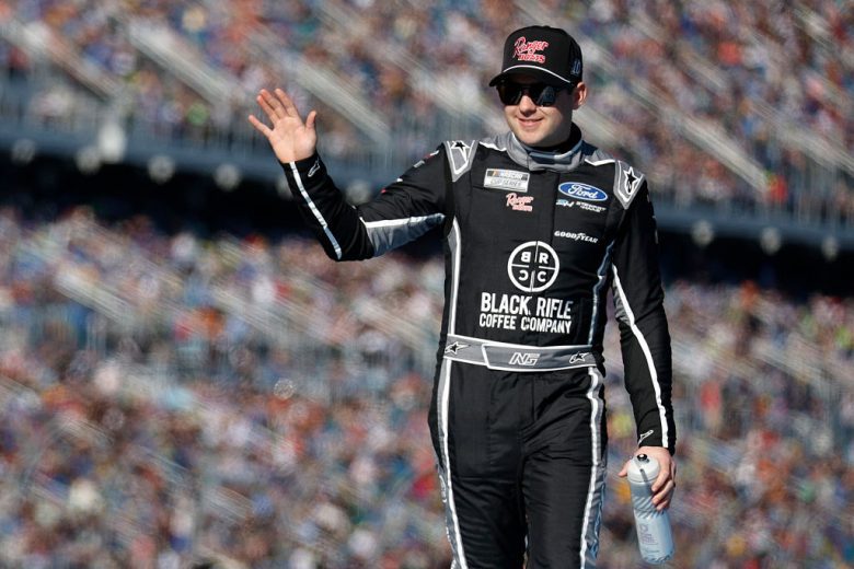 Noah Gragson waves to the crowd before a NASCAR Cup Series race.