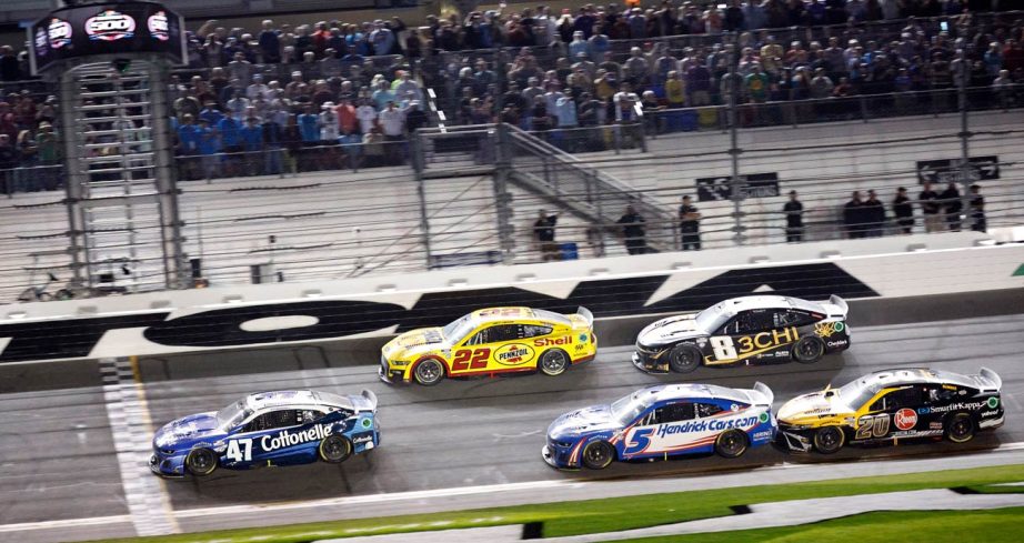 NASCAR Cup Series cars, led by Ricky Stenhouse Jr.'s No. 47 Chevrolet, cross the start/finish line during the 2023 Daytona 500 at Daytona International Speedway.