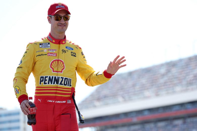Joey Logano waves to the crowd before a NASCAR Cup Series race.