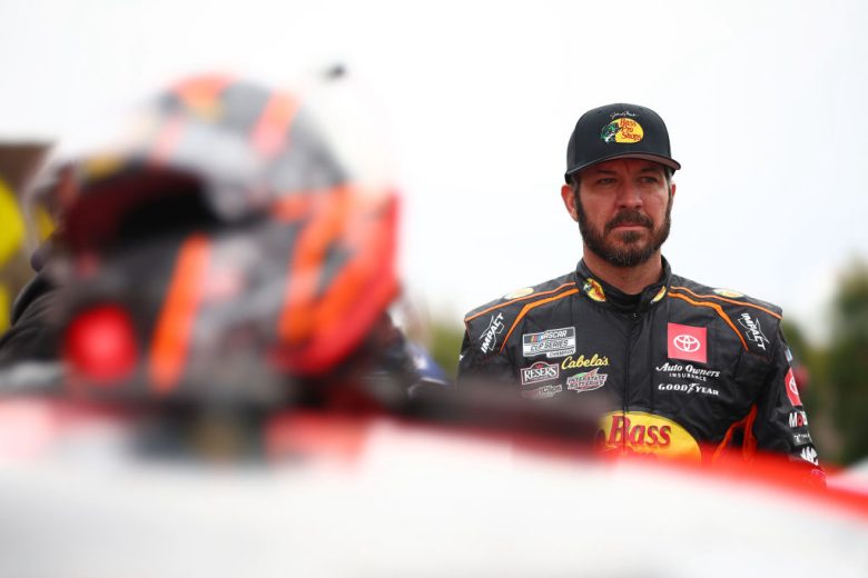 Martin Truex Jr. looks on as his helmet sits in the foreground at the Los Angeles Memorial Coliseum.