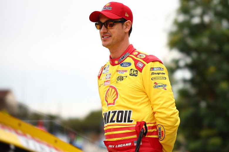 Joey Logano looks on with his arms behind his back at the Los Angeles Memorial Coliseum.