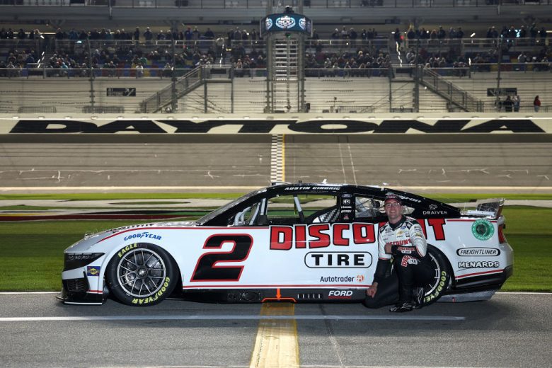 Austin Cindric poses next to his No. 2 Ford at Daytona International Speedway.