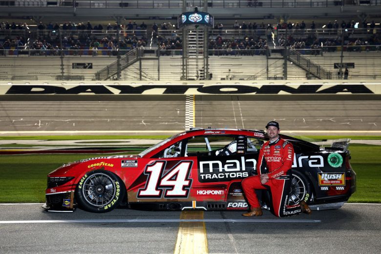 Chase Briscoe poses next to his No. 14 Ford at Daytona International Speedway.