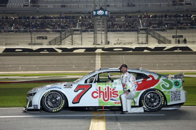 Corey LaJoie poses next to his No. 7 Chevrolet at Daytona International Speedway.