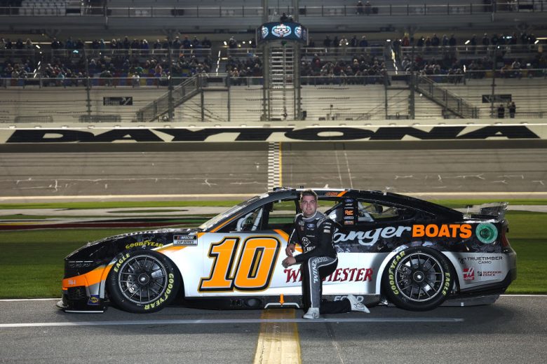 Noah Gragson poses next to his No. 10 Ford at Daytona International Speedway.