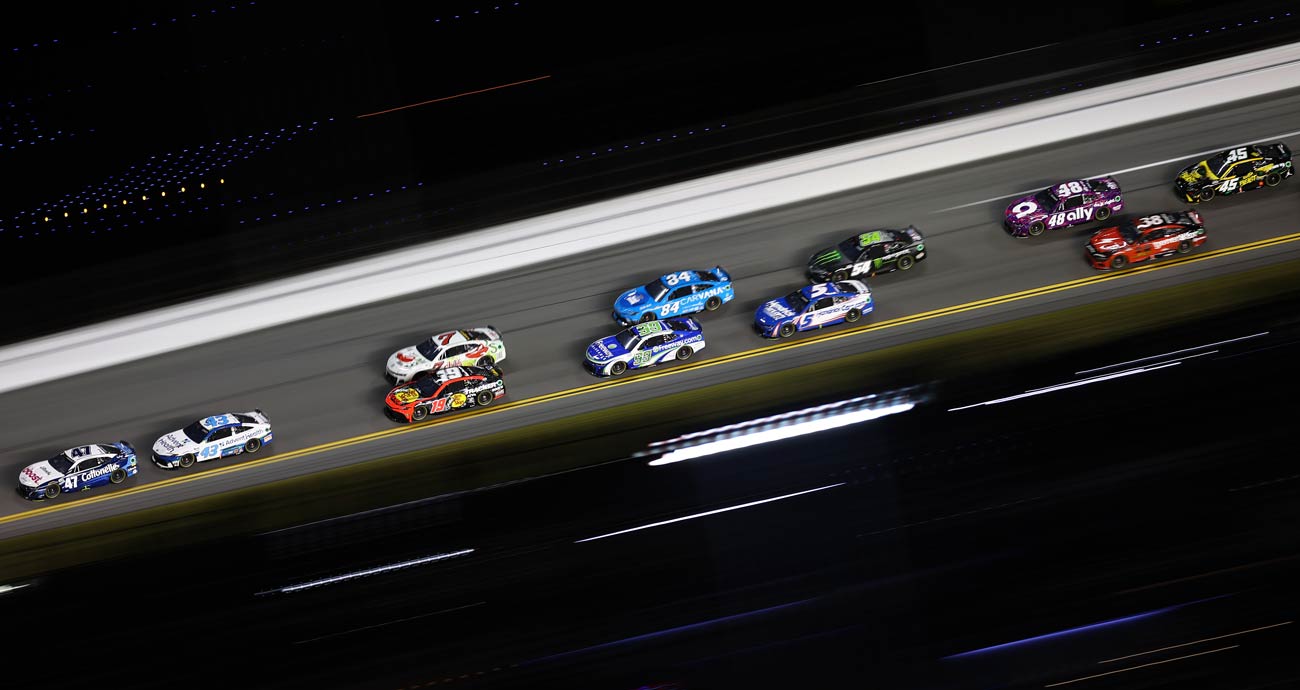 NASCAR Cup Series cars race during the Bluegreen Vacations Duels at Daytona International Speedway.