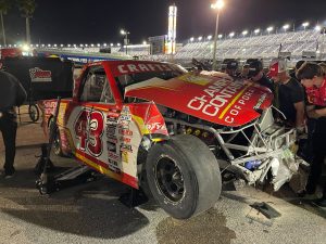 Torn up front end with exposed chasis of a race truck