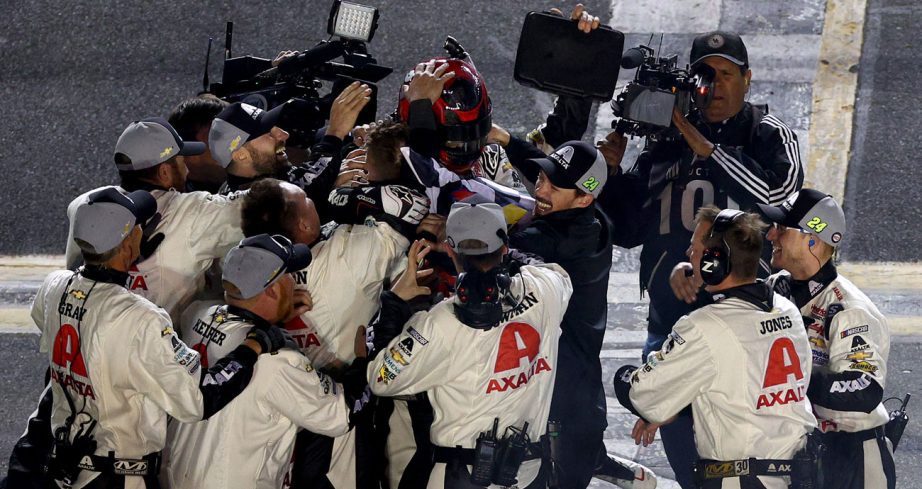 William Byron is surrounded by his team as they celebrate his Daytona 500 win