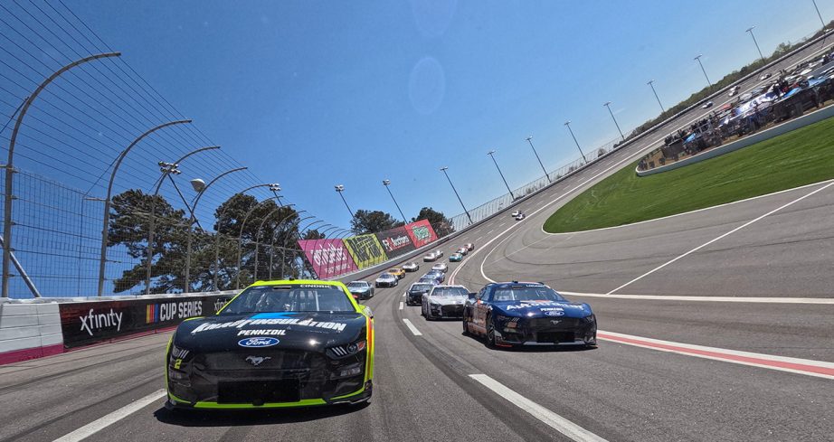 Austin Cindric, driver of the No. 2 Menards/Knauf Ford, and Joey Logano, driver of the No. 22 Autotrader Ford, lead the field on a pace lap prior to the NASCAR Cup Series Ambetter Health 400.