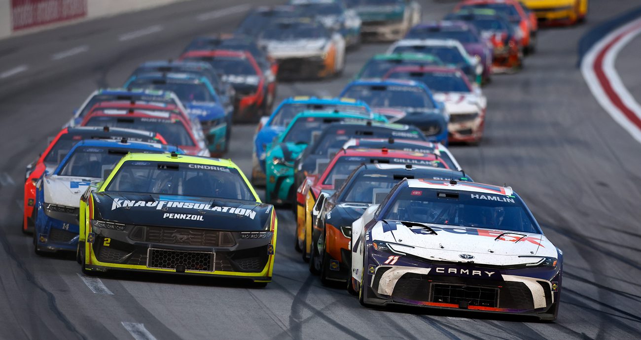 Austin Cindric in a Ford and Denny Hamlin in a Toyota lead the field in a NASCAR Cup Series race at Atlanta.