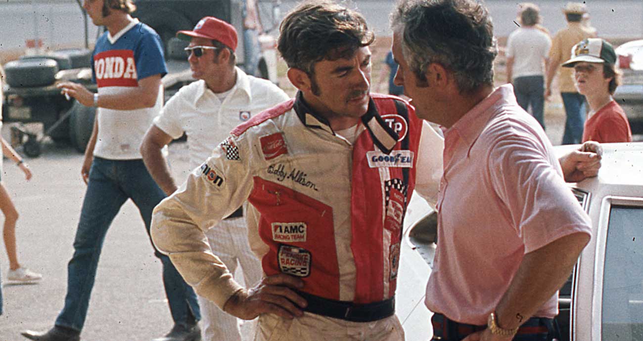 Bobby Allison and Roger Penske chat in the Cup Series garage in a mid-1970s photo