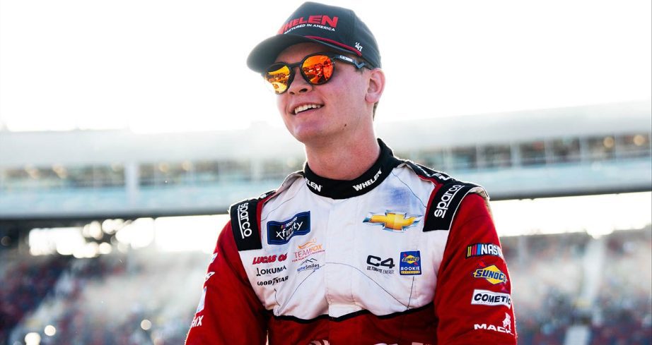Jesse Love smiles by his No. 2 RCR Chevrolet after a runner-up finish at Phoenix Raceway