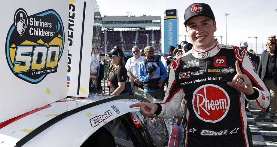 Christopher Bell poses next to winner sticker.