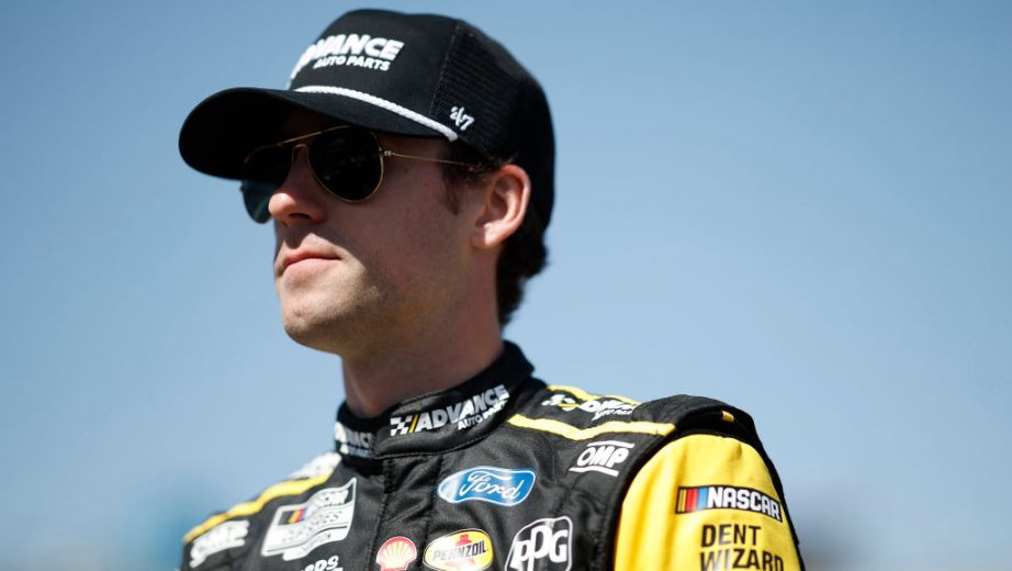 Ryan Blaney looks on.